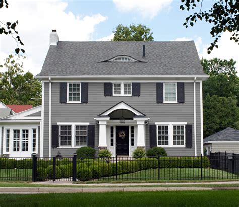 white house with grey metal roof|white house dark grey shutters.